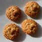 Golden brown, round pies with Mickey Mouse head pie crust decor, sprinkled with raw sugar and sitting on a white counter top.