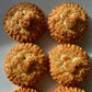 Golden brown, round pies with Mickey Mouse head pie crust decor, sprinkled with raw sugar and sitting on a white counter top. 